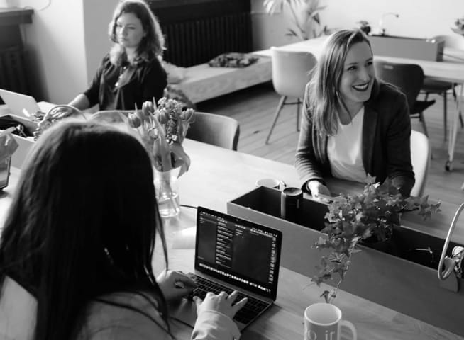 Girls working with laptop and talking